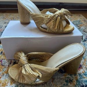 Gold slip on block heel. Pleated bow. Never worn. Size 39
